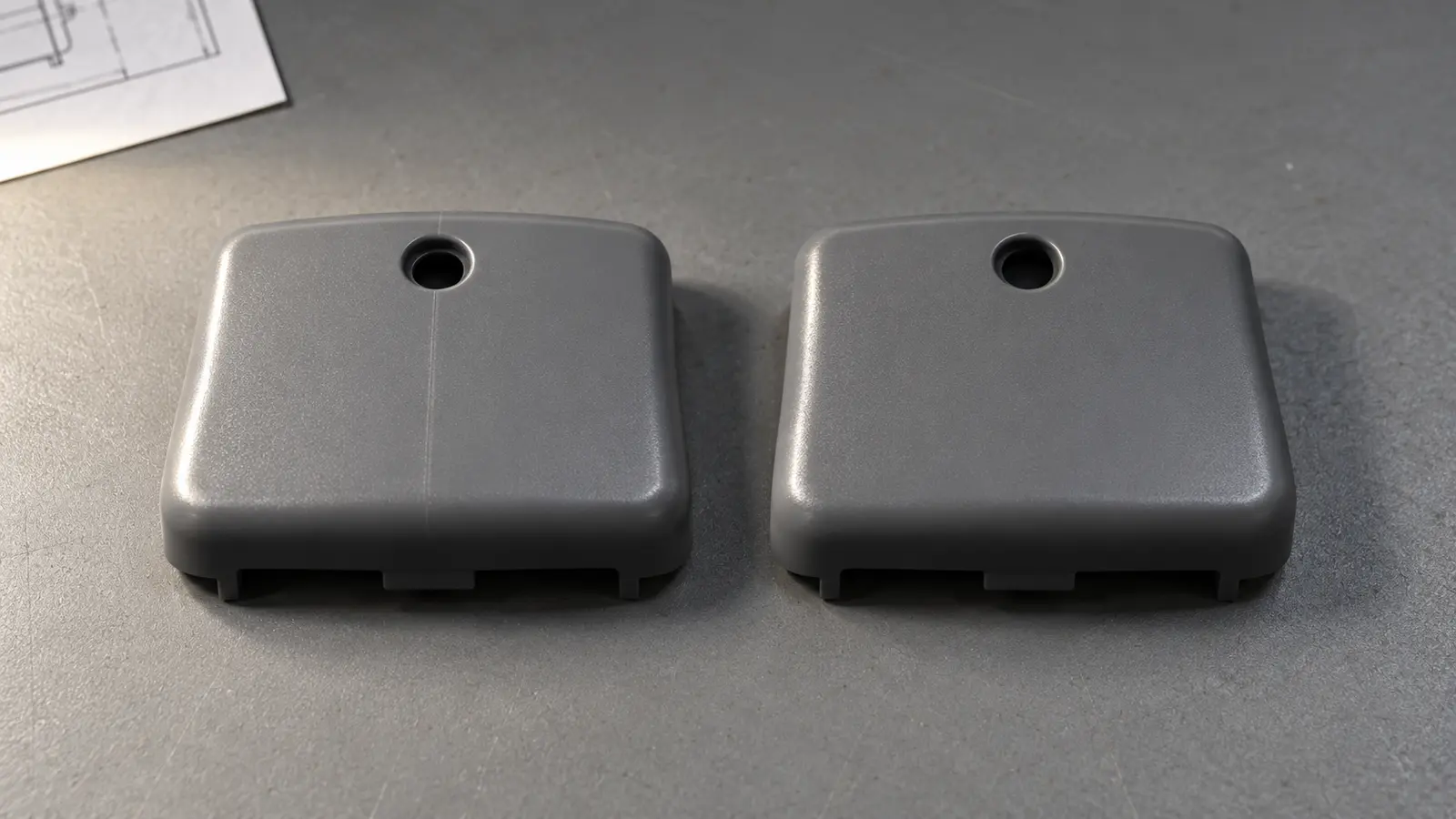 Two matching molded plastic housings from separate cycles arranged for a like-for-like visual comparison.