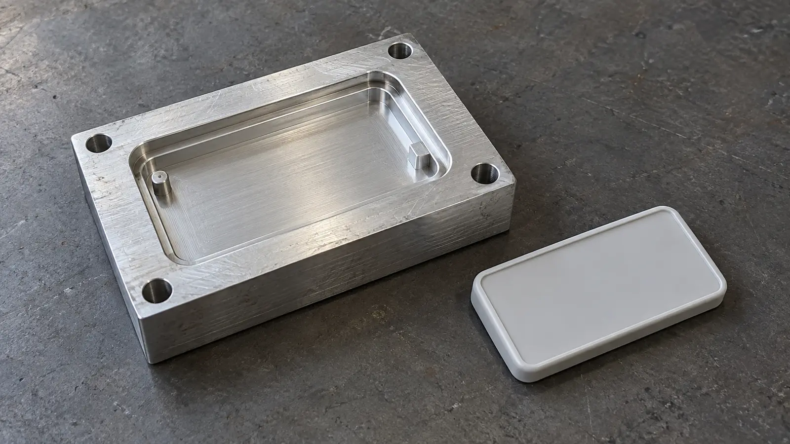 Compact aluminum prototype mold insert with a shallow cover cavity and one molded plastic cover